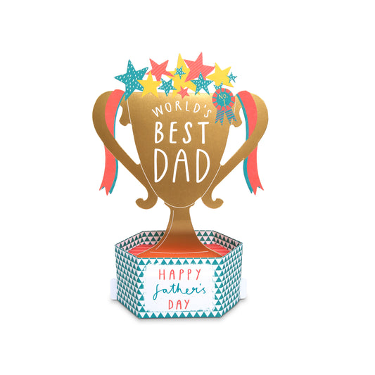 A Father's Day trophy-shaped card or decoration with a gold trophy cup reading 'WORLD'S BEST DAD,' colorful stars on top, ribbon accents, and a patterned base that says 'Happy father's day.'.
