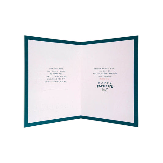 An open Father's Day greeting card with a dark teal border and white interior pages featuring short inspirational text and the words 'HAPPY FATHER'S DAY' in dark teal and light pink.