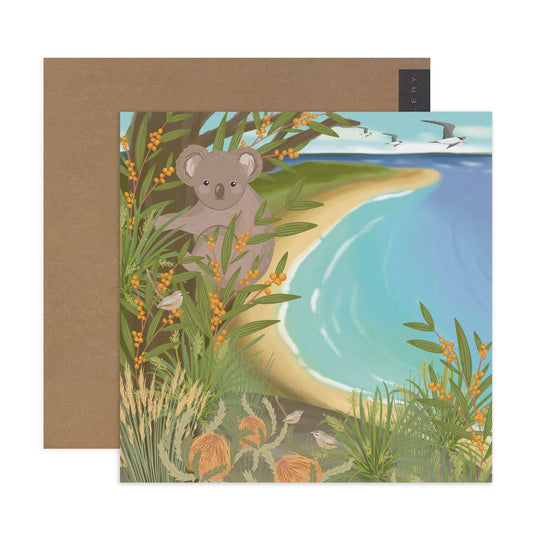 Hallmark x Christie Williams Gallery blank greeting card - Coastal with a koala illustration surrounded by vibrant greenery and beach scene.