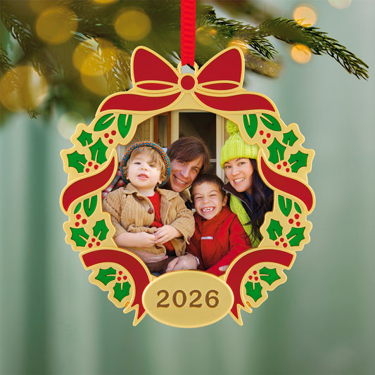 Our Family Christmas 2026 Photo Frame, Metal — 2026 Hallmark Keepsake Christmas Ornament featuring a gold wreath design with holly and a family photo.