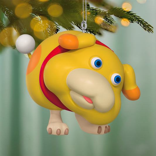 Nintendo Pikmin Oatchi — 2026 Hallmark Keepsake Christmas Ornament, yellow dog-like character, close-up view against tree backdrop.