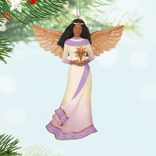 Angel of Light — Hallmark Keepsake Christmas Ornament featuring a detailed angel in a white and purple gown holding a star against a soft background.