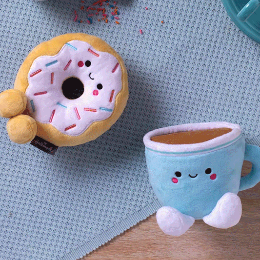 Donut and Coffee Magnetic Plush – Better Together, soft stuffed food characters with embroidered faces, flat lay on textured blue surface.