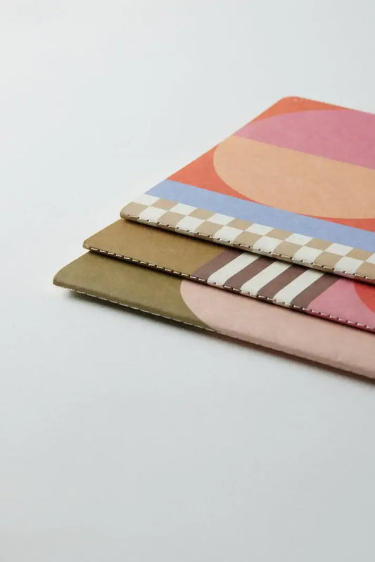 Flex Notebooks Saddle Stitch Spine Mod Geo (set of 3) with colourful abstract covers and saddle stitch design, angled view