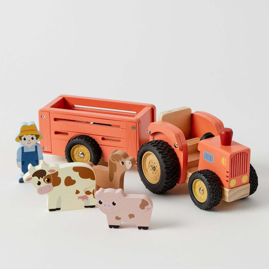 Farm Truck Set with wooden tractor, trailer, friendly farmer and cute farm animals in a flat lay view, designed for imaginative play.