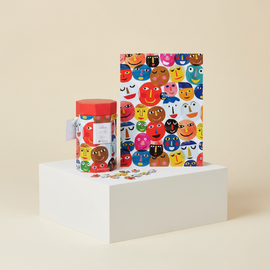 Share Smiles 550-Piece Jigsaw Puzzle (45.8cm x 61cm) box and art print on display with colourful cheerful faces.