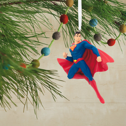Resin Figural Superman ornament hanging from a pine tree branch, bright colours and detailed design enhance holiday decorations.