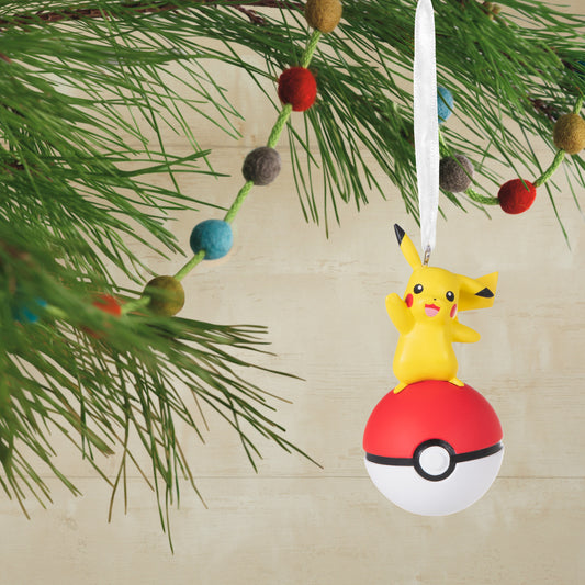 Hallmark Christmas Ornament - Pokémon Pikachu on Poké Ball hanging from a festive pine tree branch with colourful baubles.