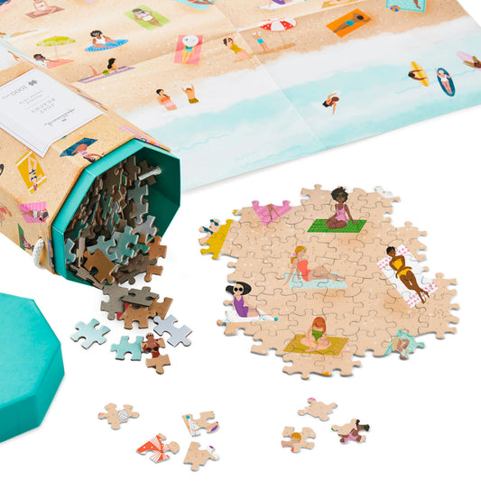 Just Beachy 1000-Piece Jigsaw Puzzle in hexagonal box, showing beach bathers pieces and a colourful beachscape surface.