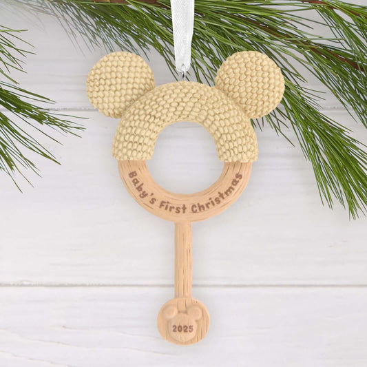 Disney Mickey Mouse Baby's First Christmas Rattle - Hallmark Christmas Ornament, wooden design featuring Mickey ears and engraved text, flat lay view.