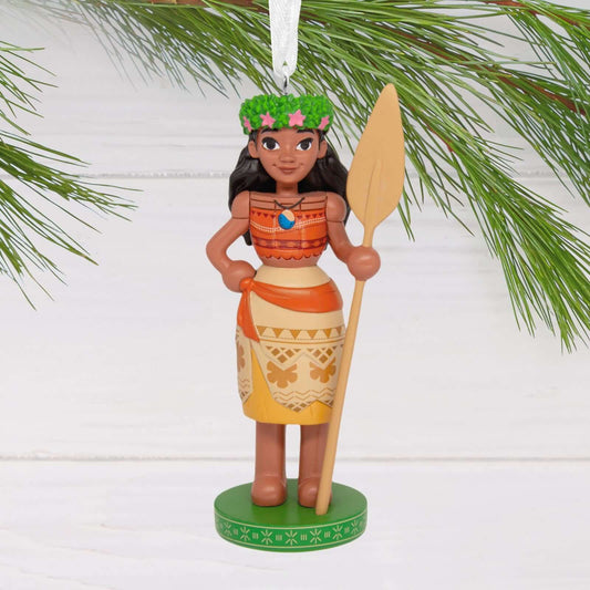 Disney Moana Nutcracker - Hallmark Christmas Ornament featuring Moana with a green crown and oar, hanging from a pine branch.