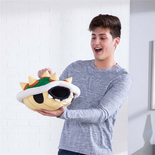 Nintendo Super Mario Bowser Shell Mega Mocchi Mocchi plush held by a young man, showcasing its soft texture and playful design.