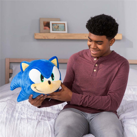Sonic Mega Mocchi Mocchi plush, soft blue pillow toy, held by a young man in a cosy bedroom setting.