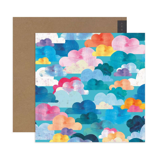 Hallmark x Kasey Rainbow Gallery Blank Greeting Card - Head In The Clouds with colourful cloud illustration, flat lay design.