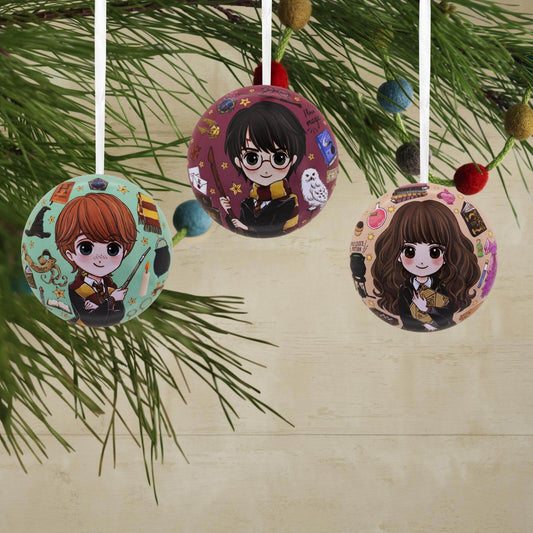 Harry Potter, tin ball, set of 12 - Hallmark Christmas ornament featuring Harry, Ron, and Hermione with whimsical designs on a Christmas tree.