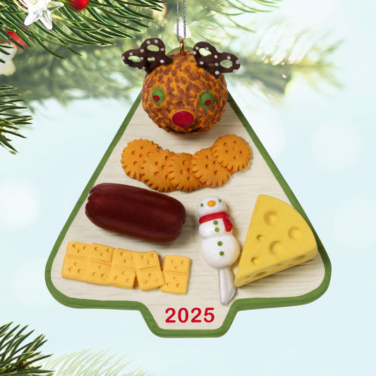 Season's Treatings, 17th in the Series — 2025 Hallmark Keepsake Christmas Ornament, Christmas tree charcuterie board featuring reindeer cheese ball and snacks, flat lay view.