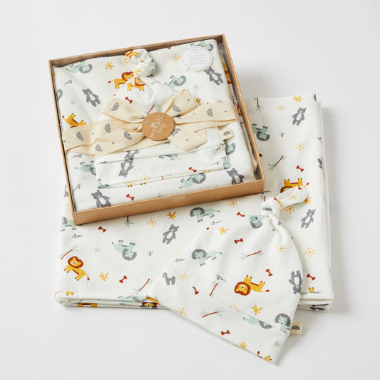Adventure Baby Wrap & Knotted Beanie Set in gift box showcasing colourful animal patterns, perfect for baby comfort and warmth.