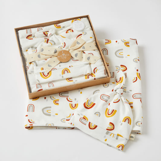 Arches Jersey Baby Wrap & Knotted Beanie Set in gift box, featuring rainbow patterns, lightweight organic cotton.