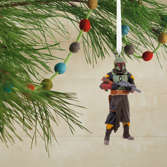 Star Wars™: The Book of Boba Fett - Hallmark Christmas Ornament features Boba Fett holding a weapon, hanging from a Christmas tree branch, with vibrant decorations.