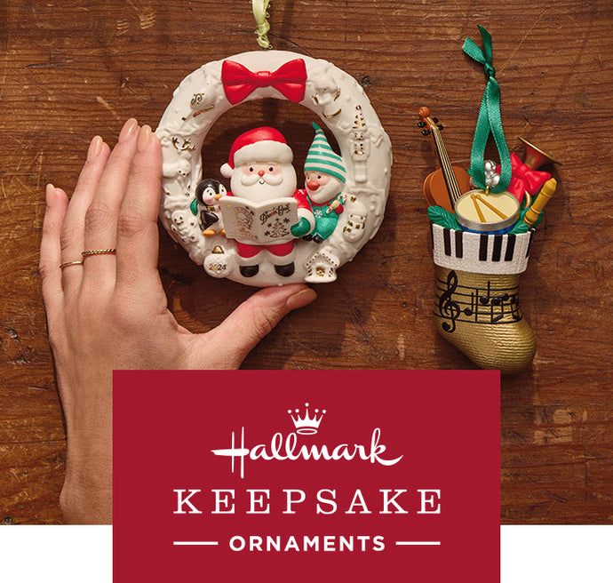 Hallmark's 2024 Keepsake Christmas Ornament Collection featuring a Santa ornament and a musical boot, viewed from above with a hand.