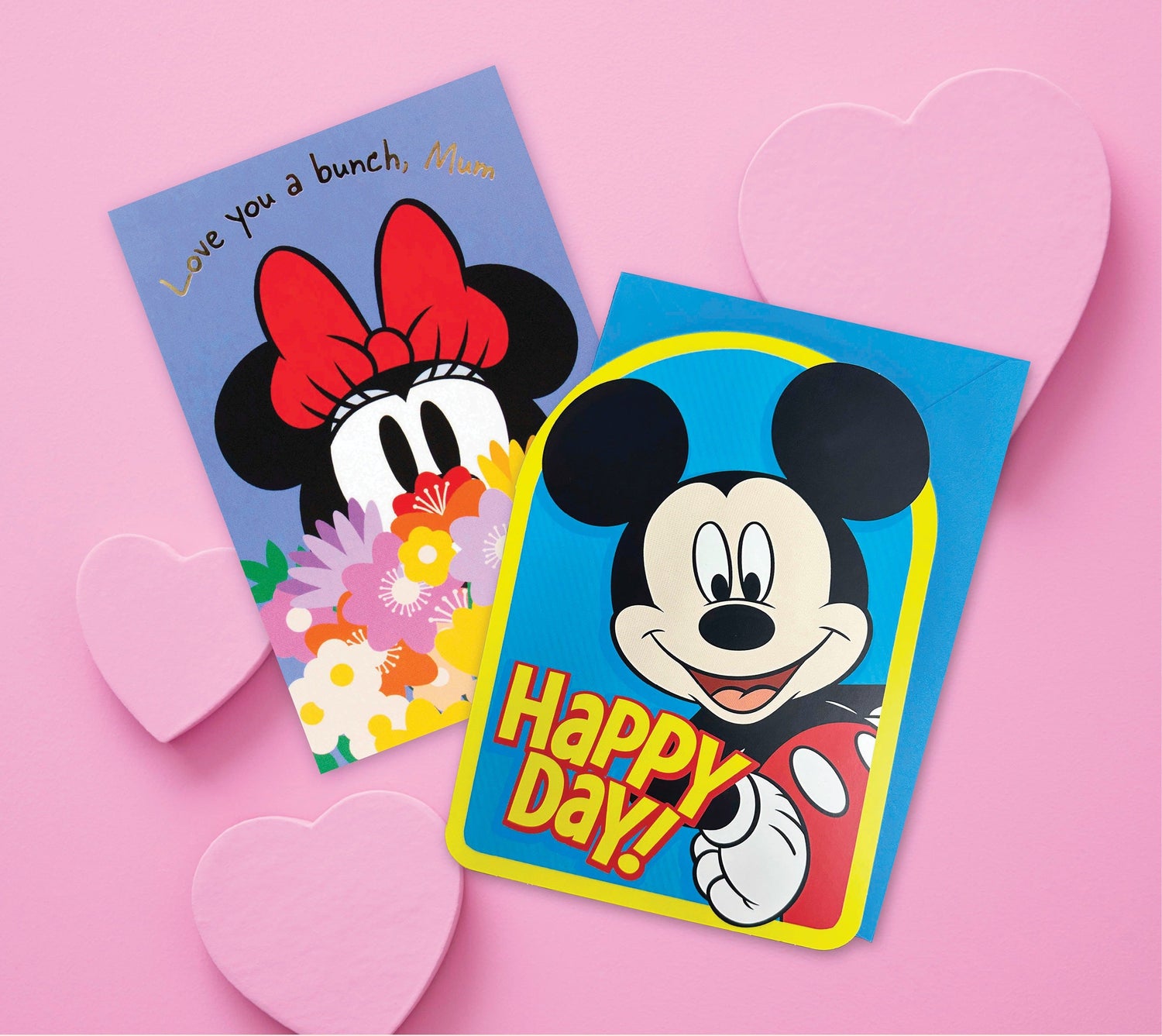Disney greeting cards featuring Mickey and Minnie Mouse with vibrant illustrations and heartfelt messages on a pink background.