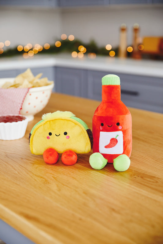 Taco and Hot Sauce Magnetic Plush – Better Together, colourful soft toys with cute faces, set against a kitchen backdrop.