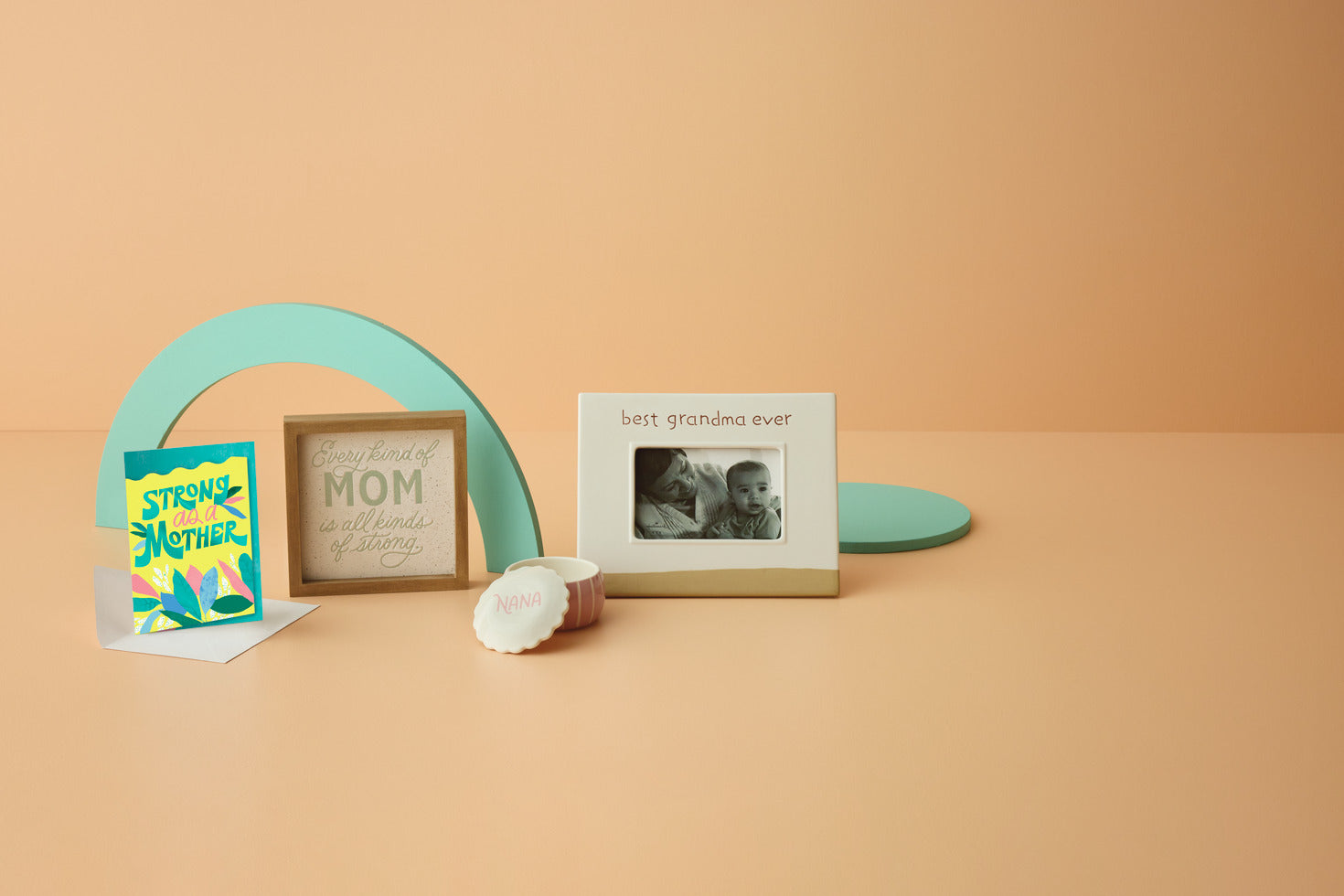 Best Grandma Ever Picture Frame, 4x6, ceramic, white and raw, angled view with decorative cards on a peach background.