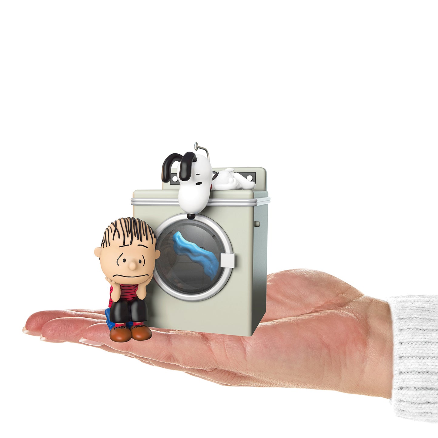 The Peanuts Gang Waiting Game With Light and Motion — 2026 Hallmark Keepsake Christmas Ornament, mini figurine of Linus and Snoopy by washing machine, held in hand.