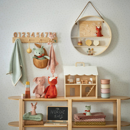 Freya Plush Bunny Rattle featured in a children's playroom with toys, decorative items, and a pastel colour scheme.