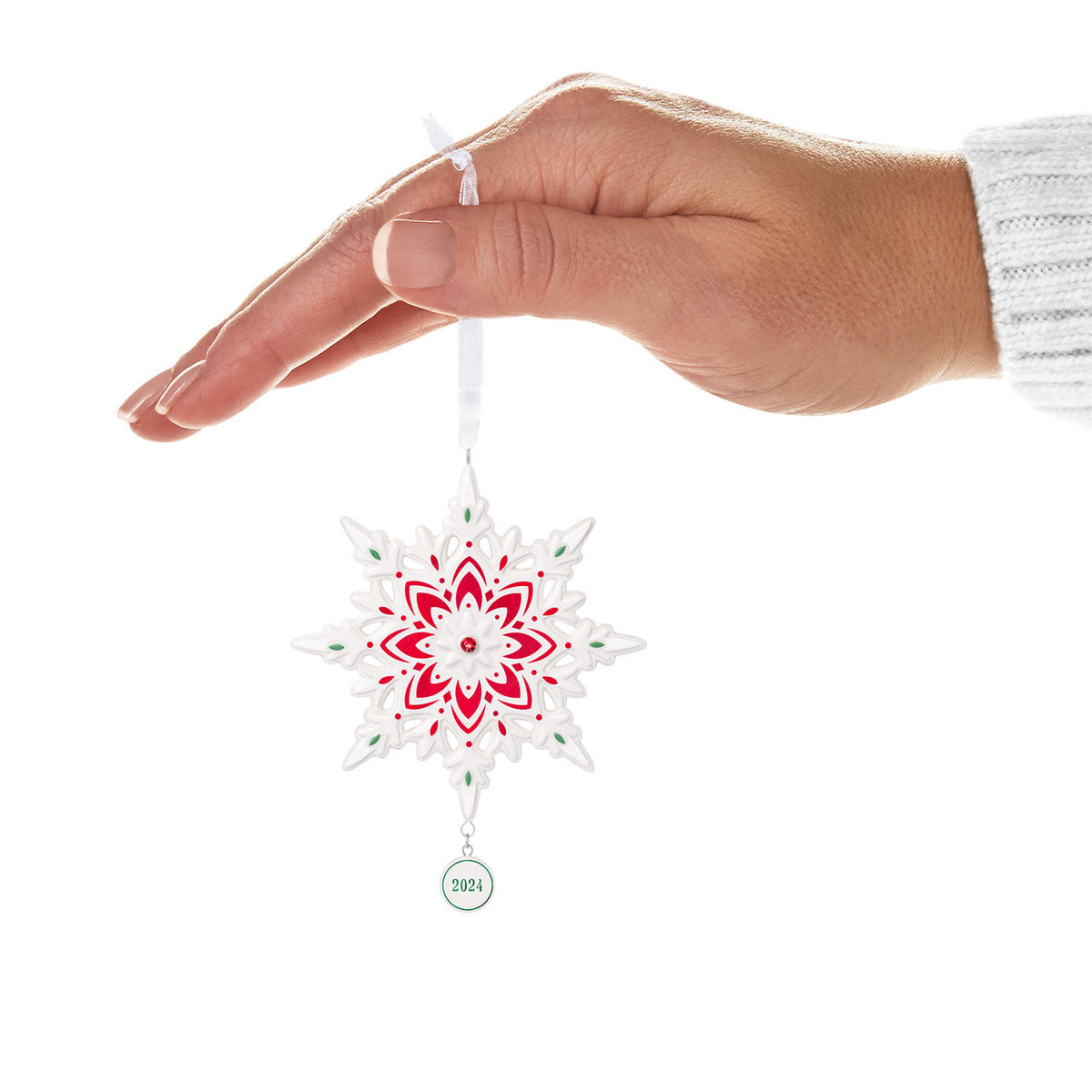 2024 Snowflake (Porcelain) — Hallmark Keepsake Christmas Ornament hanging from a hand with red and green accents, featuring a year charm.