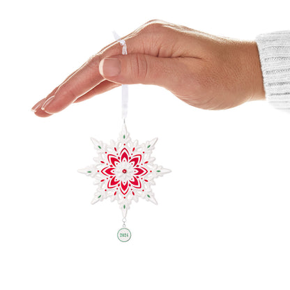 2024 Snowflake (Porcelain) — Hallmark Keepsake Christmas Ornament hanging from a hand with red and green accents, featuring a year charm.