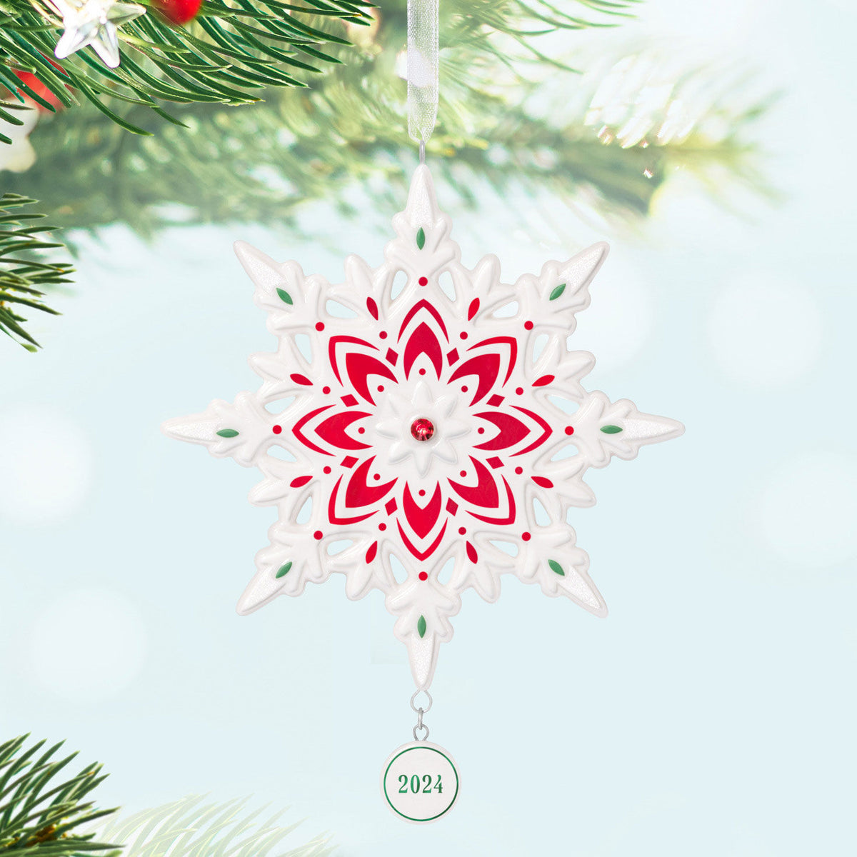 2024 Snowflake (Porcelain) — Hallmark Keepsake Christmas Ornament with shimmery red gemstone detail and painted accents, hanging on a tree.