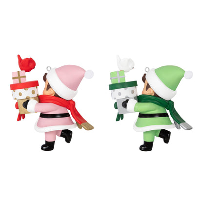 2025 Young Santa Surprise Box — 2025 Hallmark Keepsake Christmas Ornament featuring pink and green Santas carrying gift boxes and birds in a playful pose.