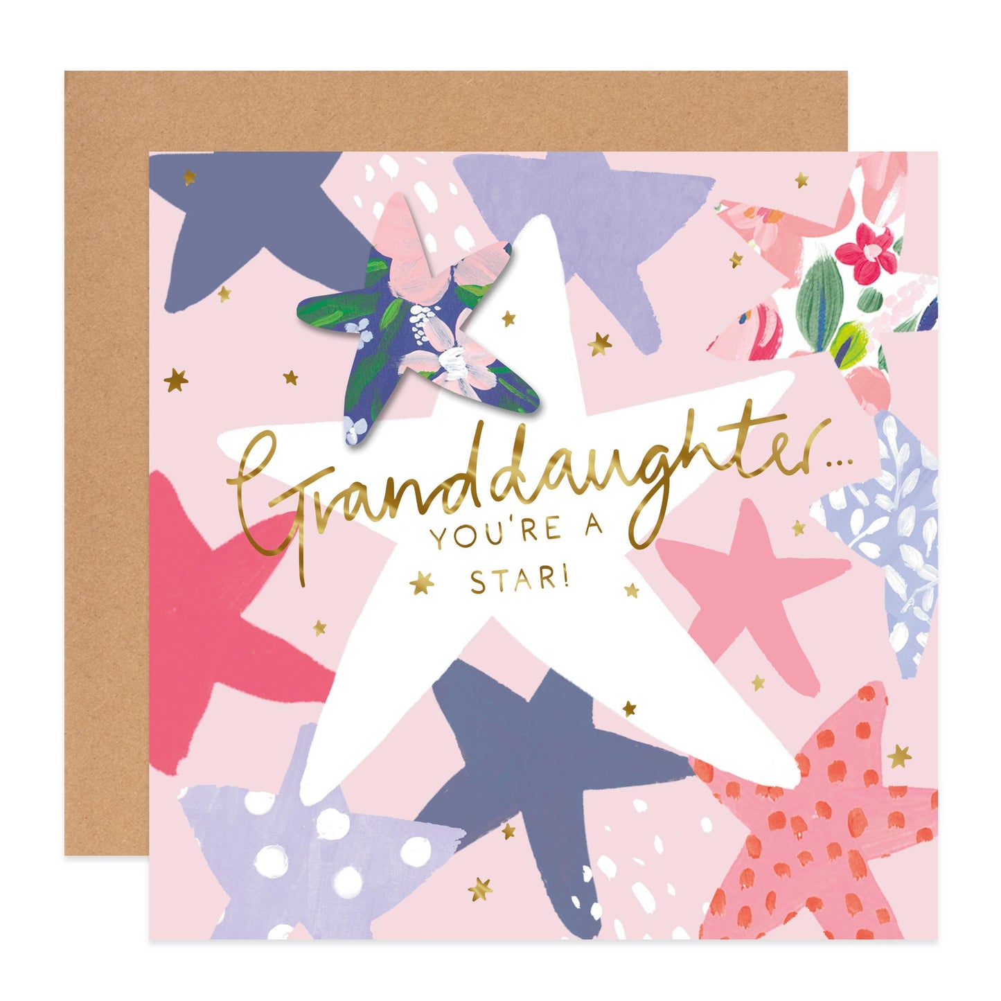 A square greeting card with a kraft envelope behind it. The card has a pastel pink background with illustrated starfish in navy, pink, purple, and coral, plus small gold stars and the text 'Granddaughter.