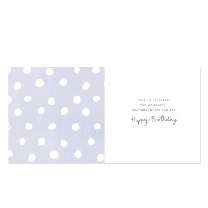 A birthday card with a split design: the left half features a light lavender background with white polka dots, and the right half is white with a short message that reads, 'TIME TO CELEBRATE THE WONDERFUL GRANDDAUGHTER YOU ARE! Happy Birthday' in dark blue text.
