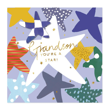 A square greeting card design featuring a large white star in the center with the words 'Grandson YOU'RE A STAR!' in gold script and block lettering. The card is decorated with multiple colorful starfish shapes in blue, yellow, green, red, and navy on a light lavender background.