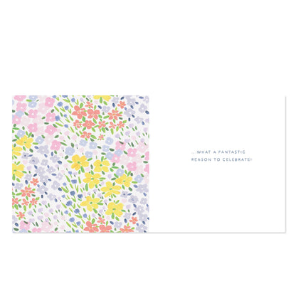 A rectangular greeting card or note with a pastel floral print on the left half and the phrase '.