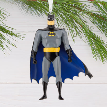 Resin Figural Batman ornament featuring a detailed design and vibrant colours, hanging from a pine branch.