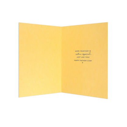 A folded yellow greeting card shown open against a white background, with small black handwritten text on the right panel reading, 'HOPE YOUR DAY IS extra special.
