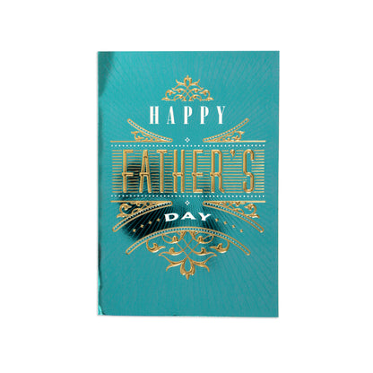 A turquoise blue greeting card with gold foil-style decorative lettering that reads 'HAPPY FATHER'S DAY' on a plain white background.