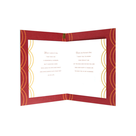 An open red greeting card with gold decorative border designs and printed Father's Day messages on a white interior, shown against a plain white background.