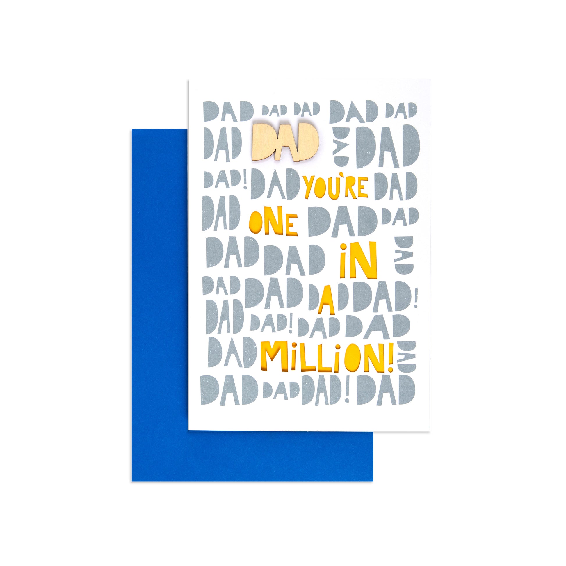 A white greeting card with playful repeated 'DAD' text in gray and yellow, reading 'YOU'RE ONE IN A MILLION! DAD', shown with a blue envelope behind it on a white background.