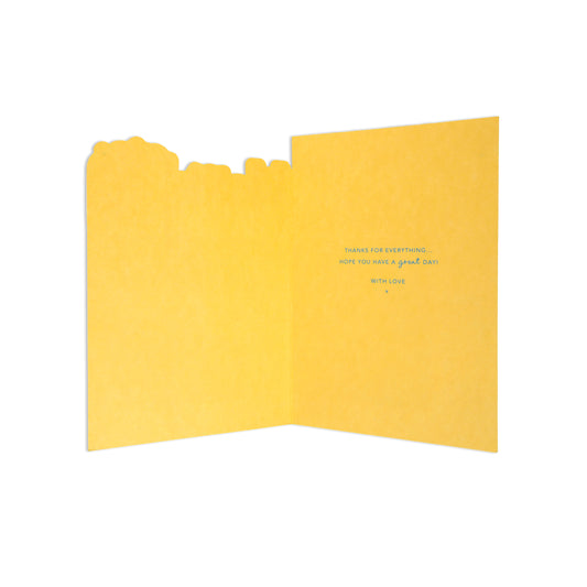 A folded yellow greeting card with a decorative cutout top edge, shown open against a plain white background. Small blue text is printed on the right panel.