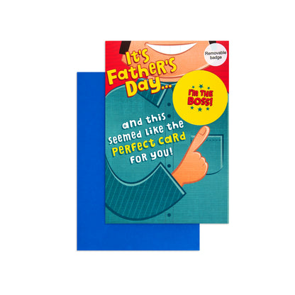 A Father's Day novelty card with a bright blue envelope behind it. The card features a cartoon illustration of a person pointing upward, with text that reads 'It's Father's Day.