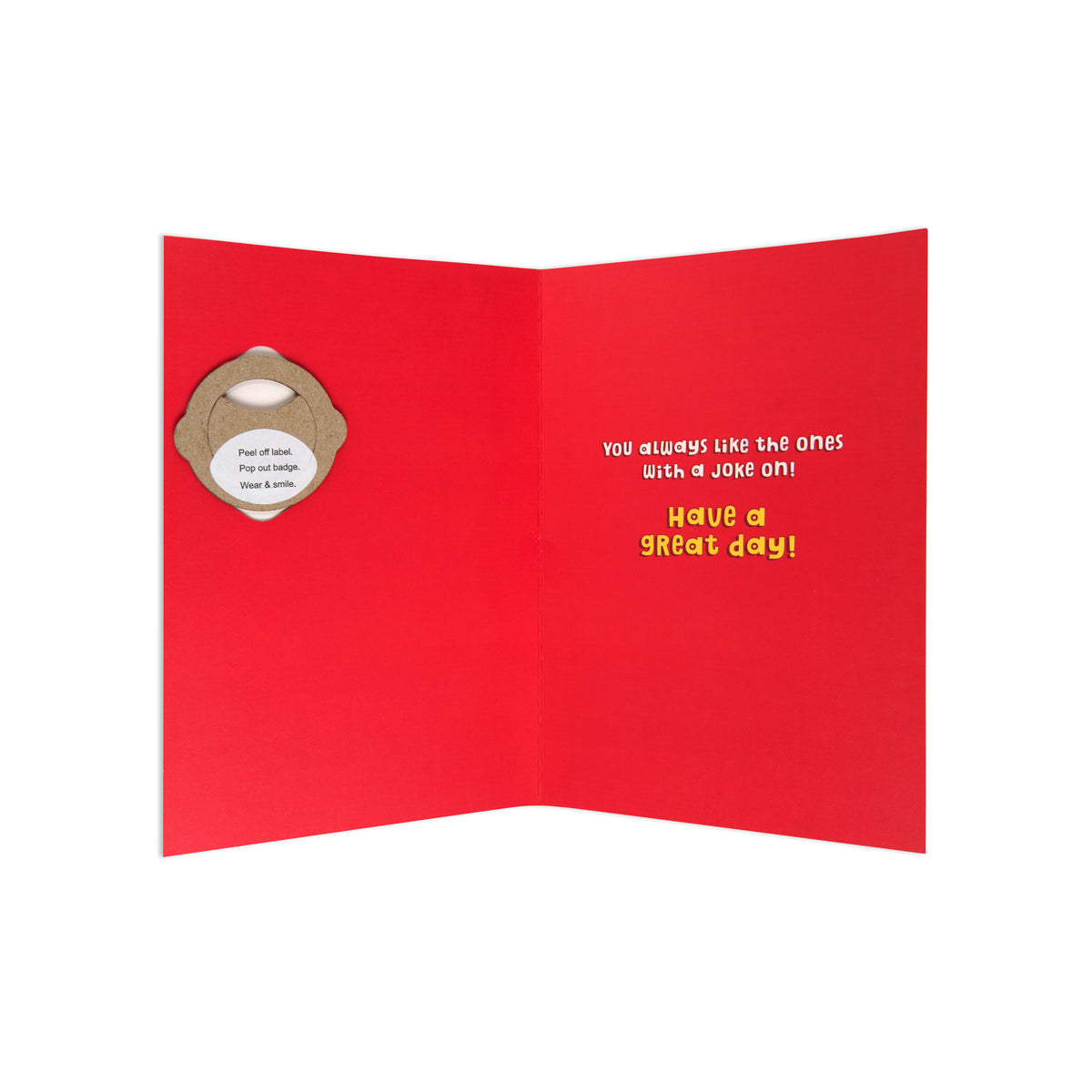 A red greeting card shown open against a white background, featuring a small bottle-cap-shaped cutout on the left side and yellow text on the right that reads, 'you always like the ones with a joke on! Have a GREAT day!'.