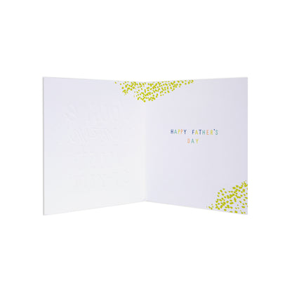 An open white Father's Day greeting card with small multicolored text reading 'HAPPY FATHER'S DAY' and yellow-green confetti accents near the top and bottom corners, shown on a plain white background.