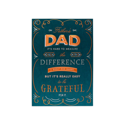 A rectangular Father's Day greeting card or sign with a dark teal background and decorative orange and white typography. The text reads, 'On Father's Day, DAD it's hard to measure the difference, a great dad makes, but it's really easy to be grateful for it.