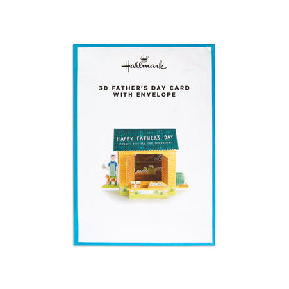 Hallmark 3D Father's Day card with envelope, featuring a small illustrated market stall and a blue border on a white card.