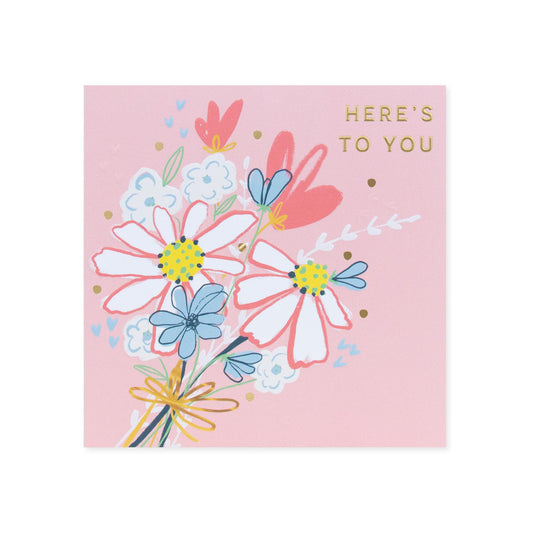 Hallmark Floral Birthday Card with floral illustrations, pink background, and gold foil detailing; close-up view.