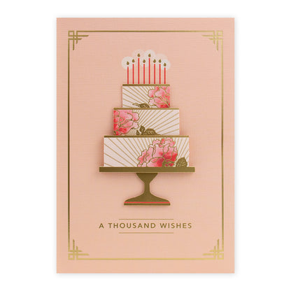 Hallmark Signature Birthday Card - Thousand Wishes featuring a three-tiered floral cake design with gold foil accents and birthday candles.